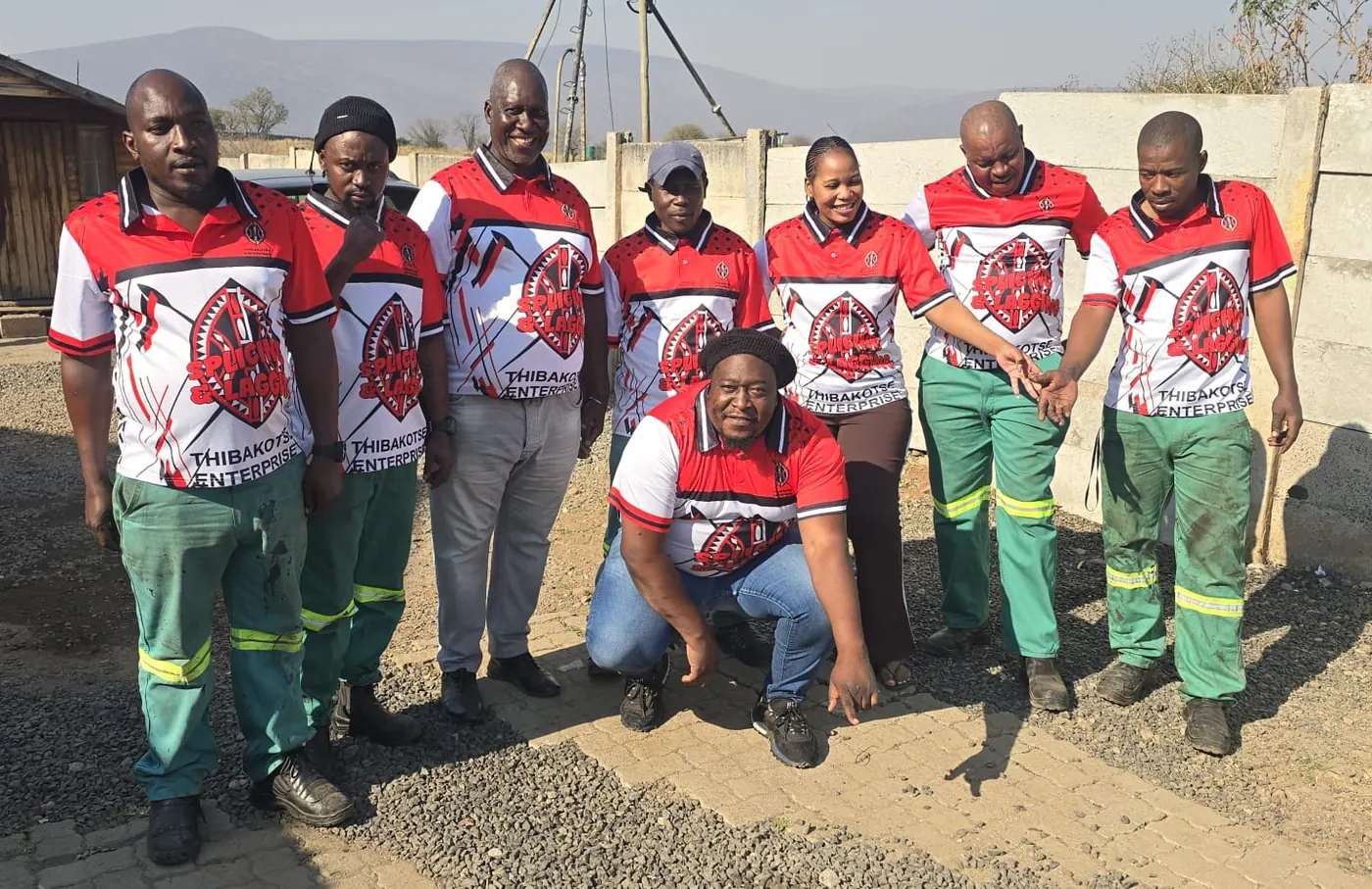 The Thibakotse Enterprise team in branded splicing and lagging shirts